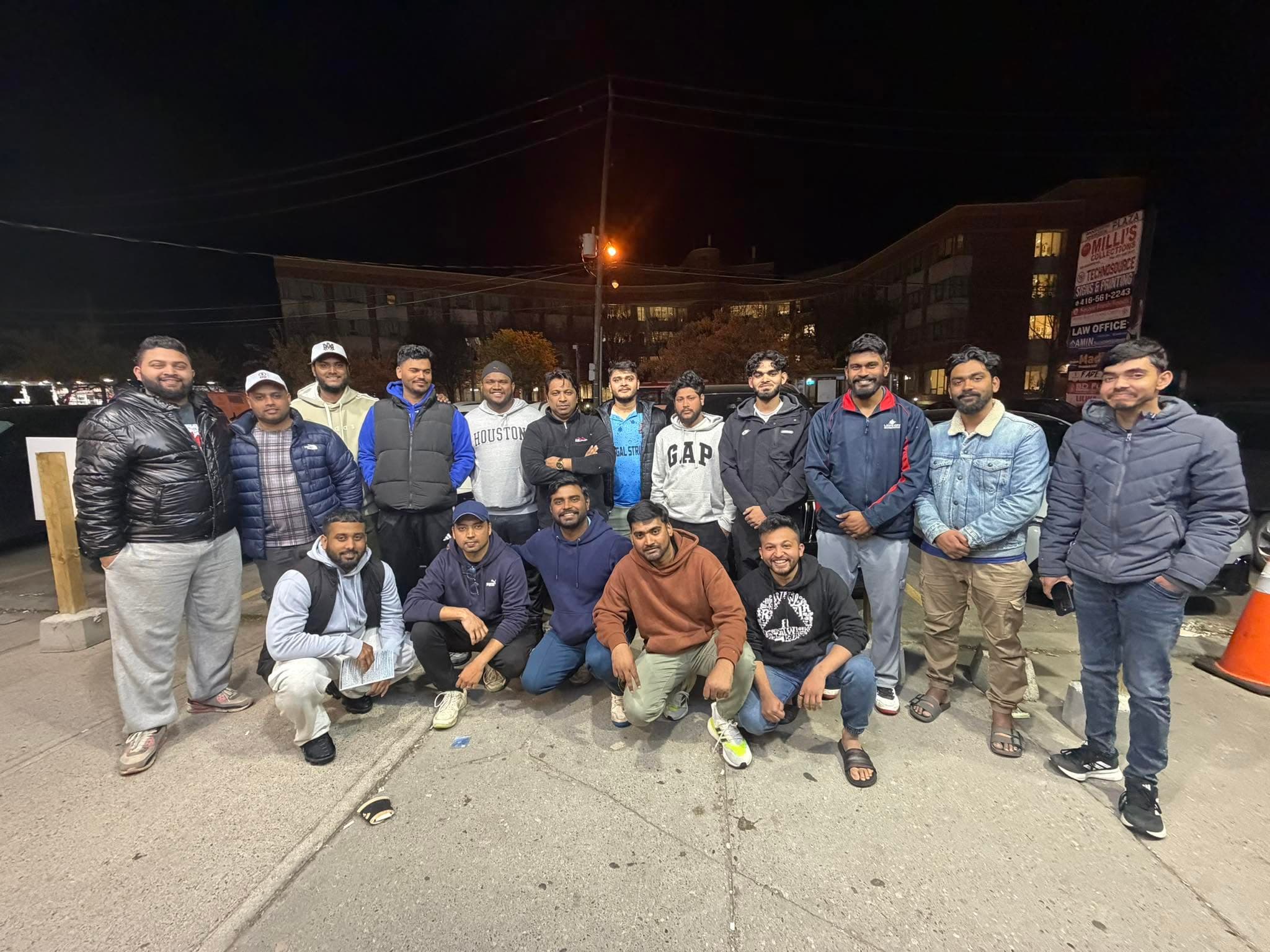 Murshed Nizam with a group of young community members at night