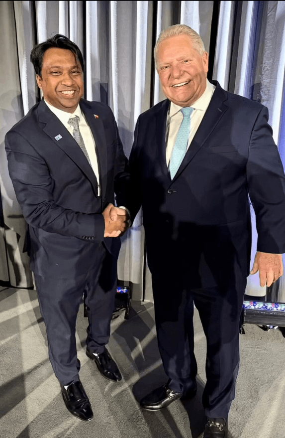 Murshed Nizam shaking hands with Doug Ford indoors